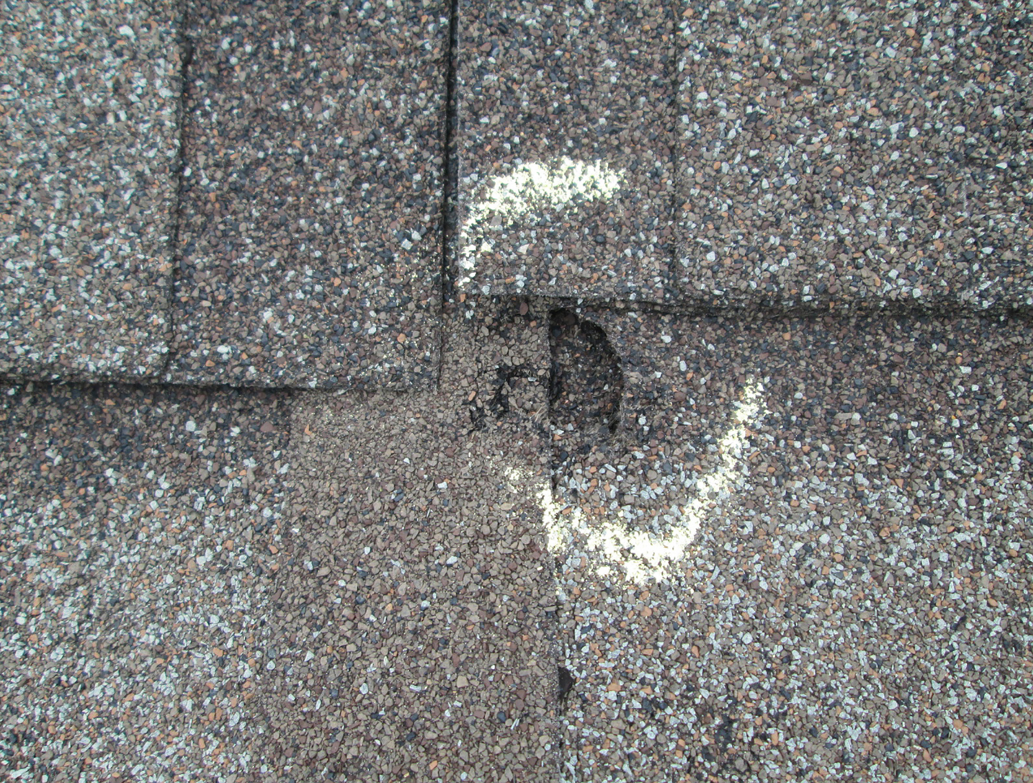 Storm Damage on an asphalt shingle roof