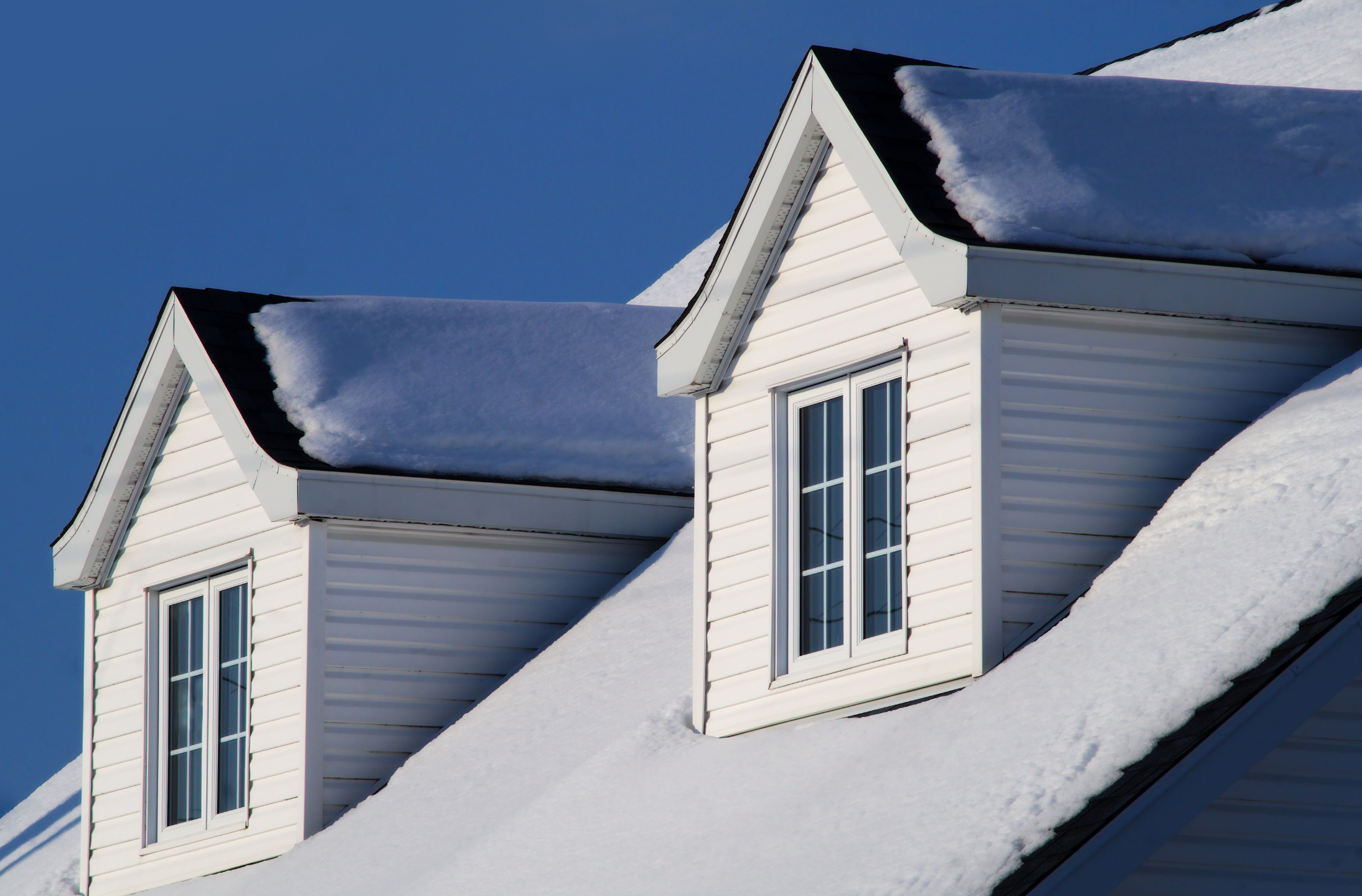 Snow topped roof on a suburban house